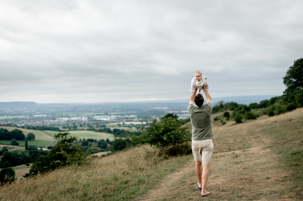dad and baby walking in the countryside with views